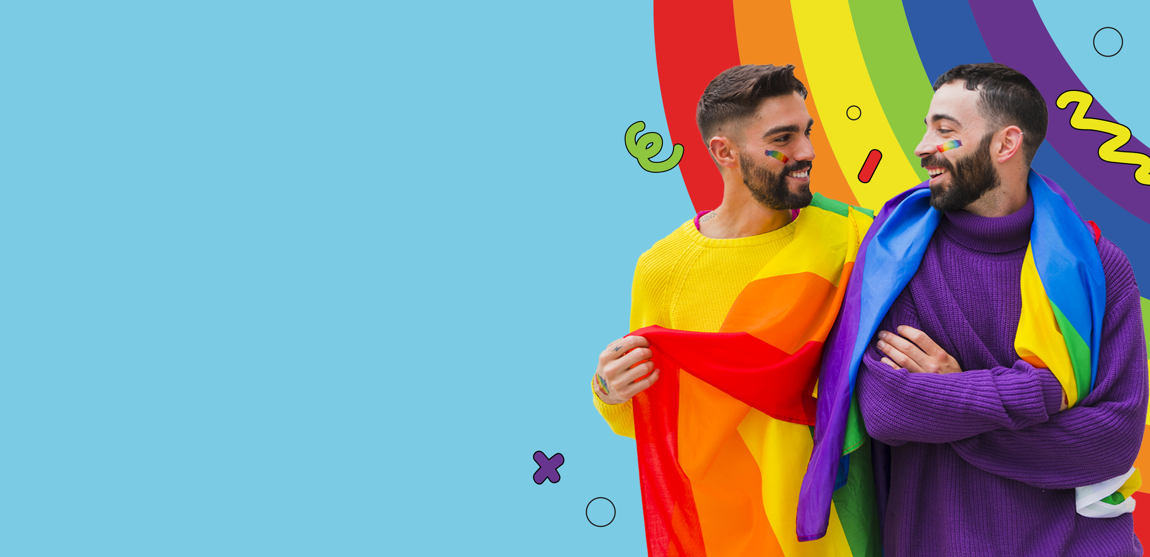 Two men standing in front of a rainbow smiling at each other with rainbow paint on their cheeks holding a pride flag